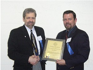 Robert Corey (r), test engineer, Northrop Grumman, and chapter vice president, accepts a lifetime membership certificate from Thomas Rachfalski, chapter president, during the April meeting.